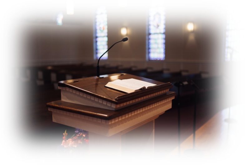 Church pulpit with open book and microphone.