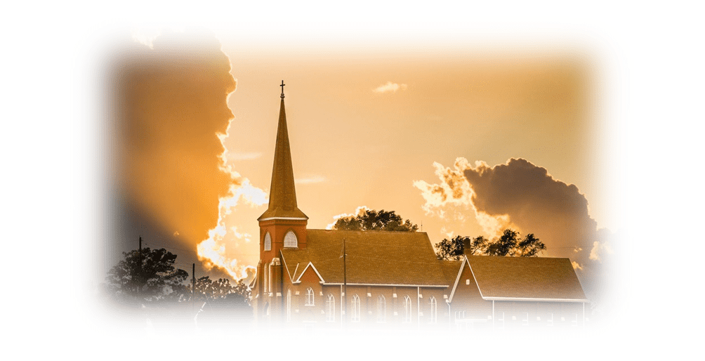 Church steeple at sunset with clouds.